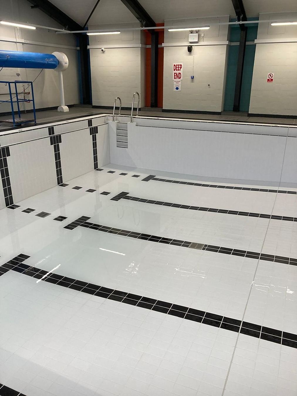 The basin fully retiled and epoxy grouted, ready for refill.