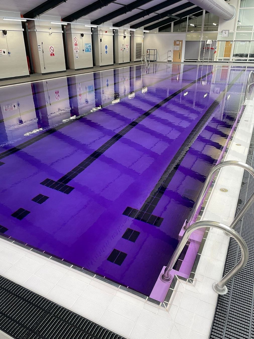 Purple tracer dye in the refilled pool. The colour is intentional and makes the water circulation visible.