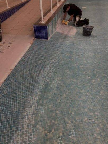 Curved pool tiling: Detail work around a curved mosaic-tiled pool feature.