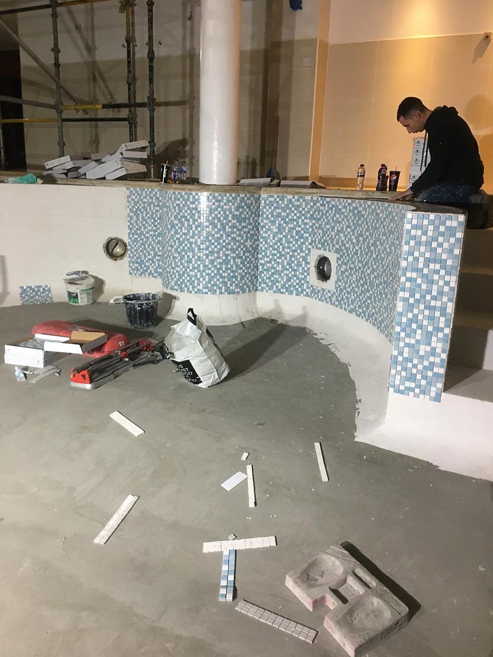 New mosaic going on to the curved wall around the column seat.