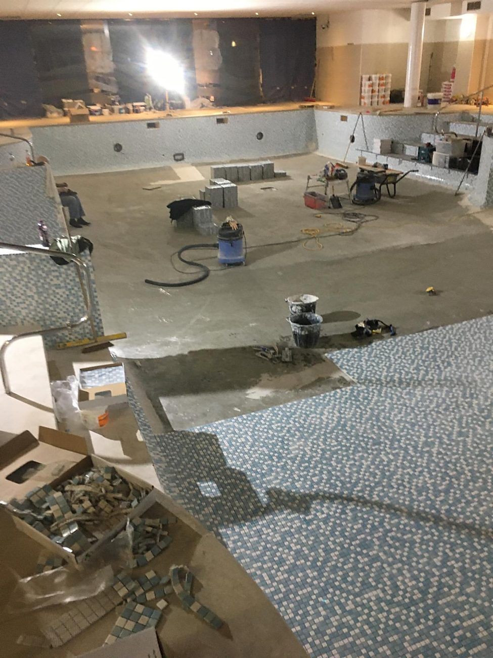 Floor mosaic going down across the basin.