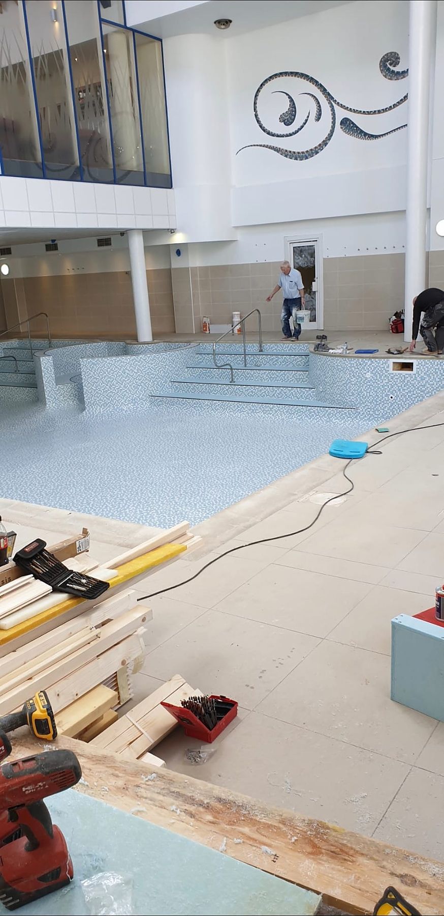 The pool hall during the works, with the mosaic wave feature on the wall.