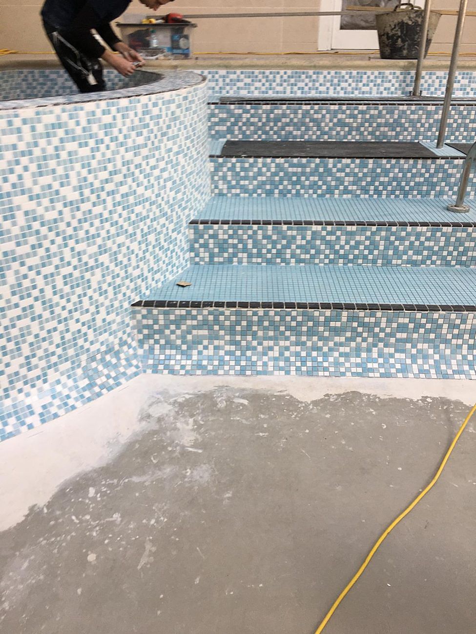 The step treads tiled, with black nosings along the edge of each step.