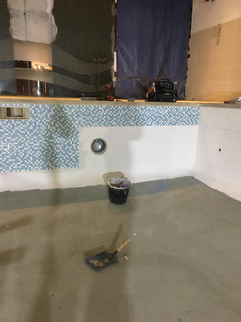 The walls tanked, with the first runs of new blue and white mosaic on the back wall.