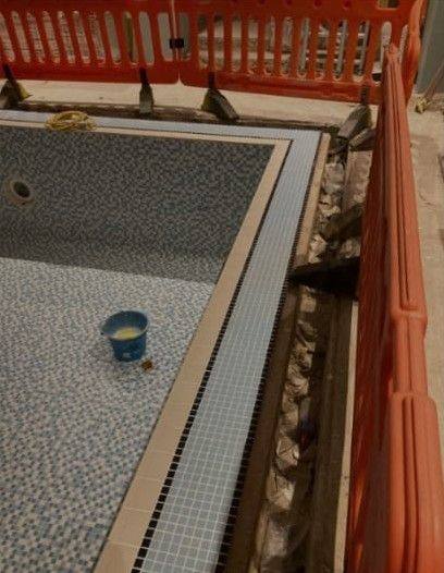 Edge detailing: Mosaic finish and channel detail at the pool perimeter.