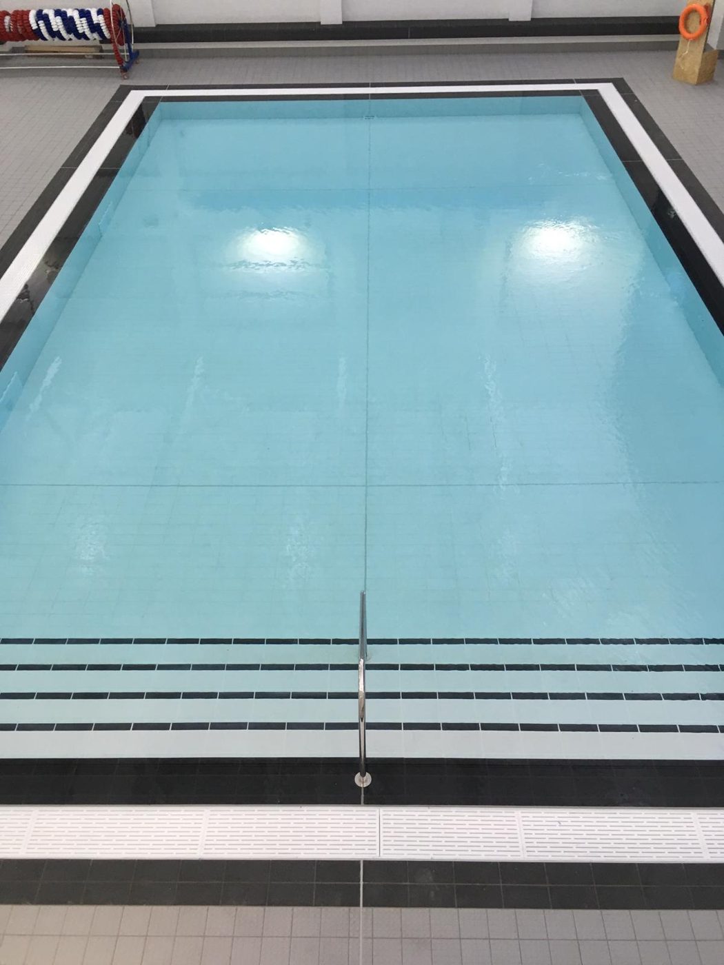 Learner pool entry steps with contrasting edge bands.