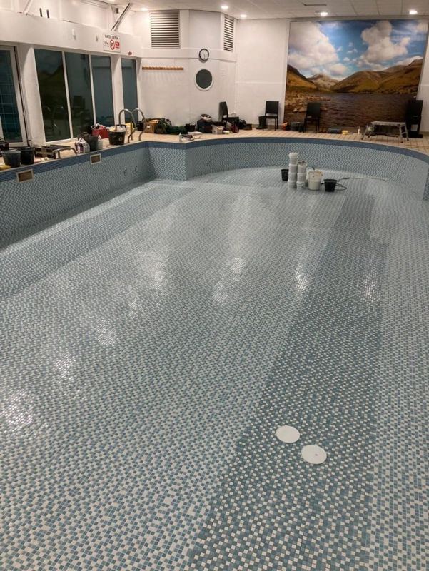 Mosaic floor and the curved pool wall.