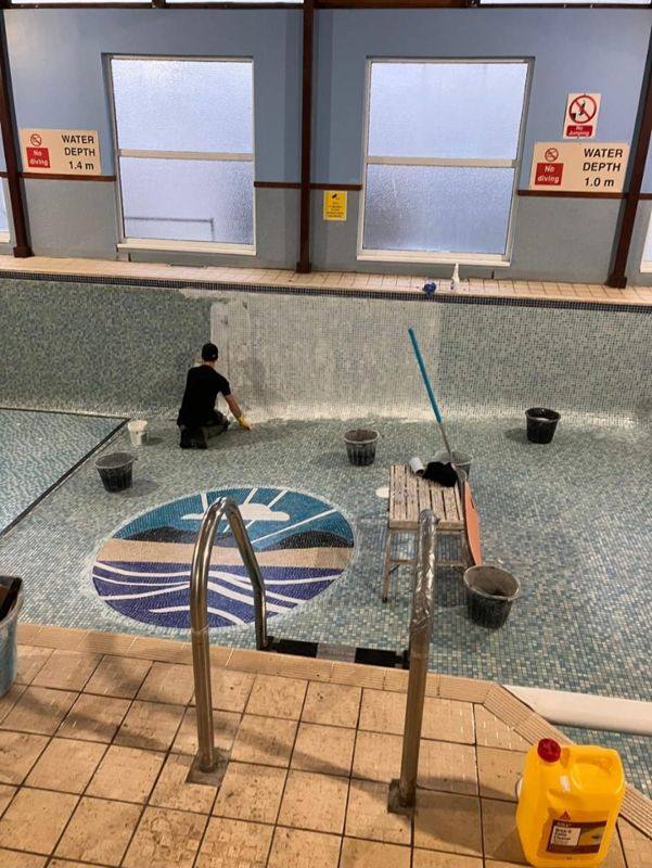 Work on a mosaic pool floor