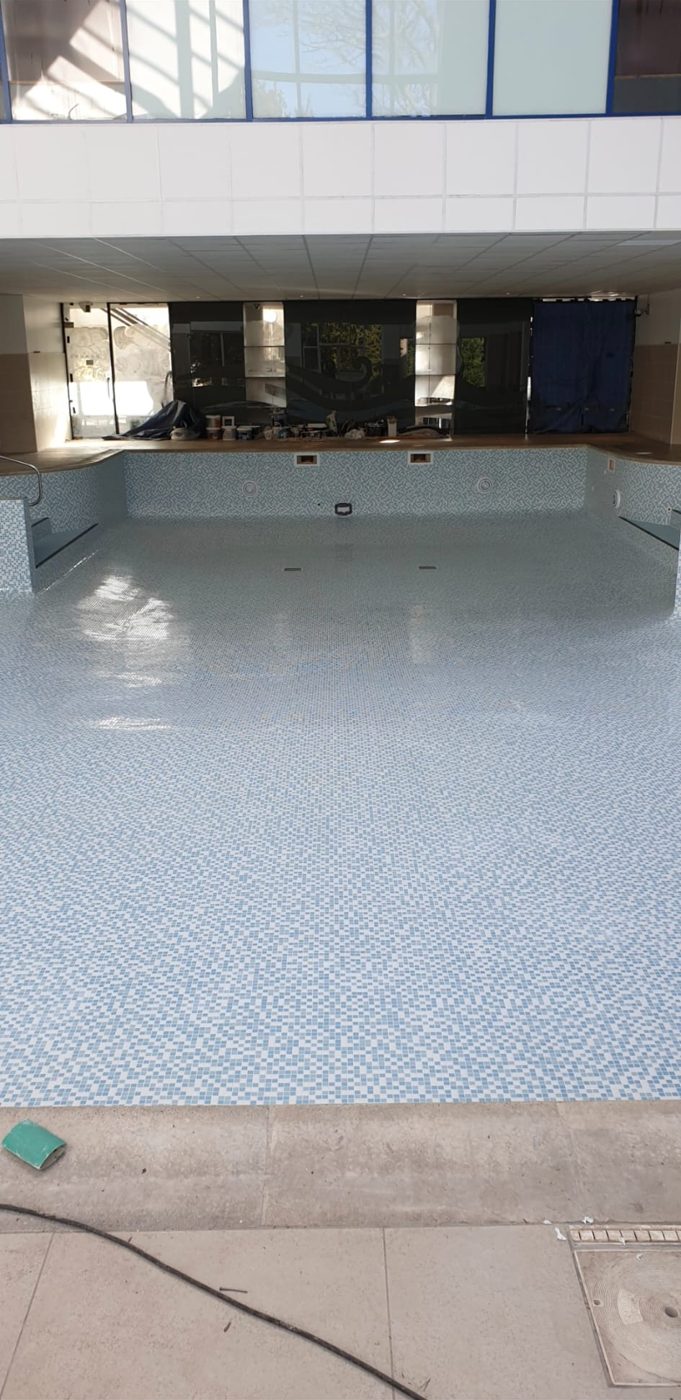 Mosaic tiling across the pool floor and walls.
