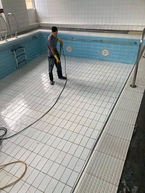 Drained pool being washed down